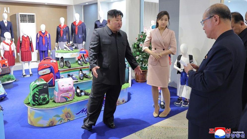 Kim Jong Un with his daughter Kim Ju Ae addressing officials  
