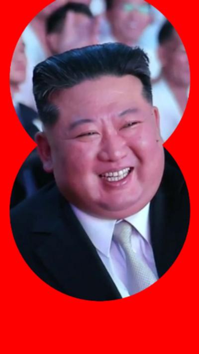 Kim Jong Un has short black hair and is wearing a black suit with a white shirt and a light grey tie.