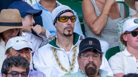 Ali G sits amongst tennis fans in stands, as he watches the Wimbledon Mens Final