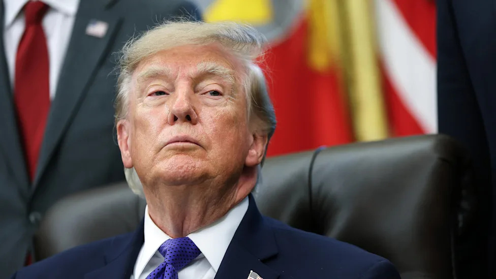 President Donald Trump listens