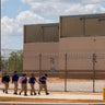 People walk toward the entrance of the South Texas ICE Processing Center in Pearsall, Texas, on Sept. 21, 2026. 