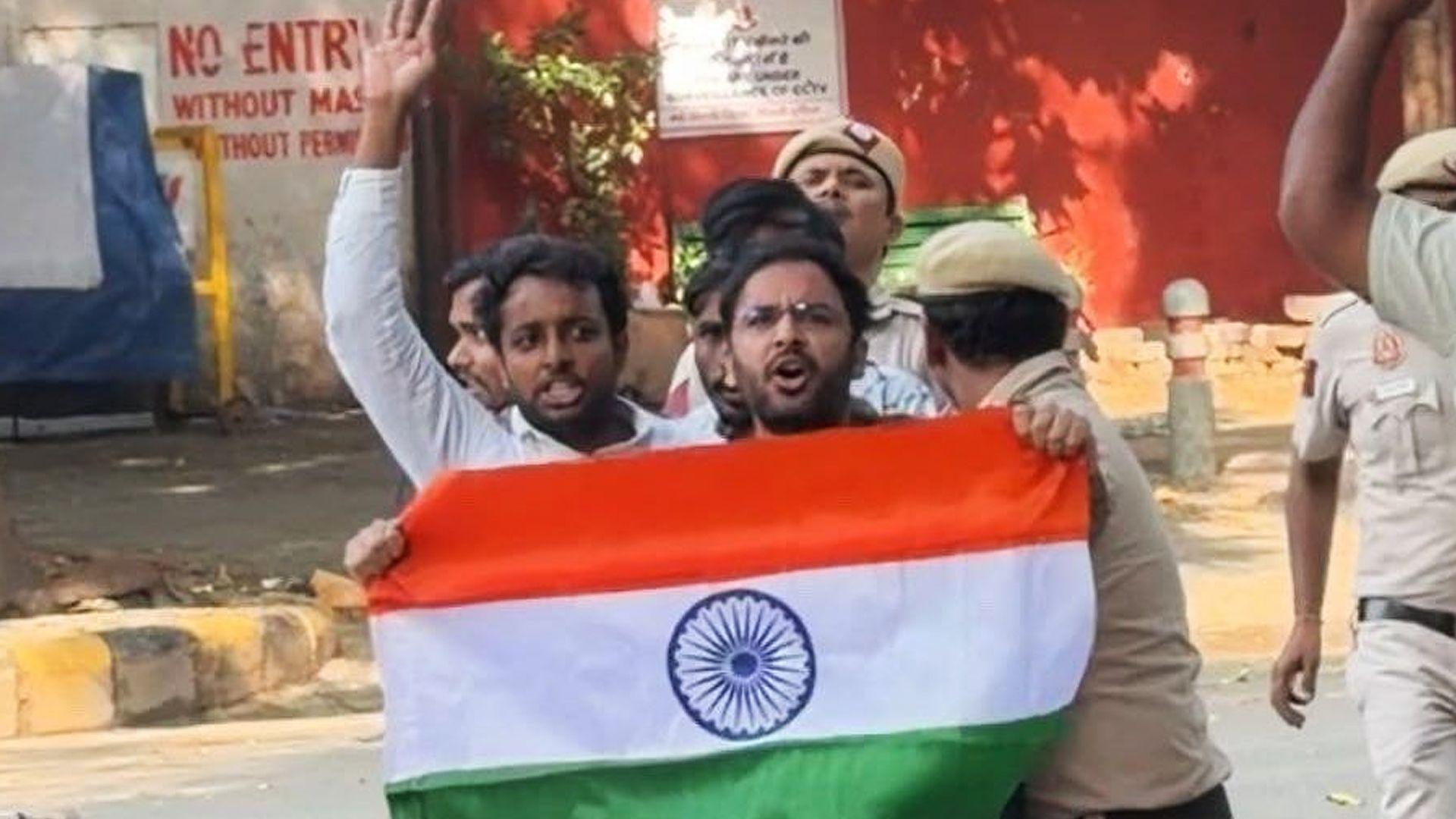 Ashutosh Ranka seen holding the Indian flag with police dragging him