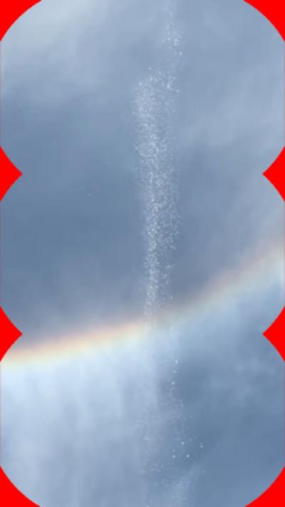 Image appears to show water pouring from a blue sky.