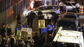 Protesters near the scene where a man was shot by an Immigration and Customs Enforcement (ICE) officer during an operation in the Bronx borough of New York