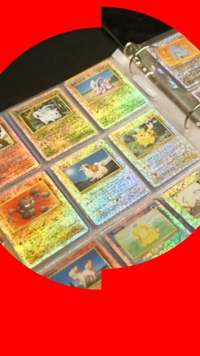 A collection of Pokemon cards sitting in a binder 