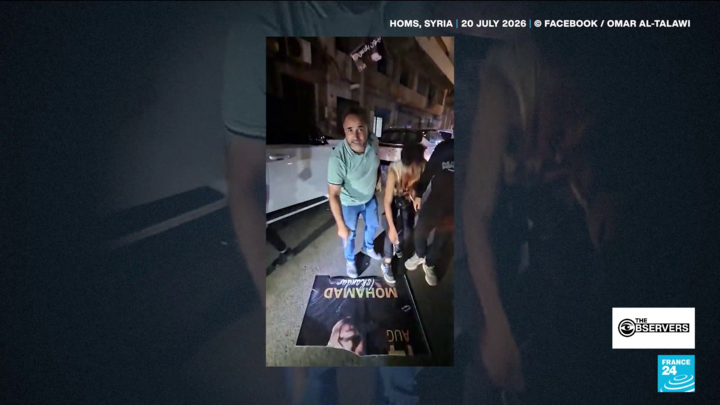 Cover image: Screenshot of a video showing men tearing down posters advertising a concert featuring Syrian singer Mohammad Iskandar in Homs in July 2026.