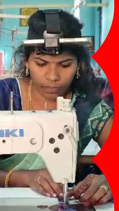 A woman with a camera attached to her head works at a sewing machine