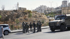 Israeli soldiers gather at the scene of a shooting attack carried out by Palestinian gunmen at a junction near Hebron in the occupied West Bank on Friday, Oct. 23, 2026.